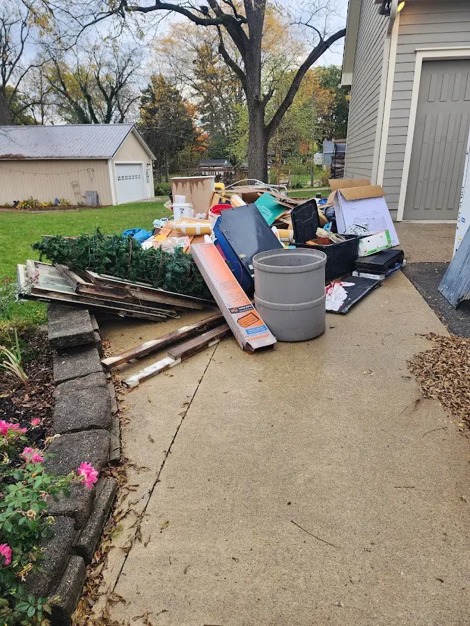 Dumpster being loaded with debris for Roofing Dumpster Rental in Rockford